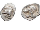 two ancient silver coins with a lion head and a lion ' s head