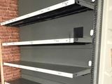 many shelves that are in the middle of a room