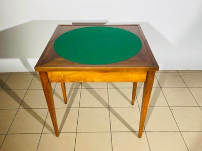 une petite table avec un plateau vert posée sur un sol carrelé