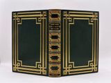 an old black and gold book with gold trimmings on it