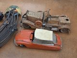 a toy car and a toy truck sitting on the floor