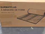 packaging for a memory foam mattress in a cardboard box on a table
