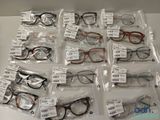 many pairs of eyeglasses in bags on the table
