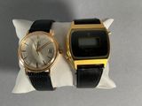 two watches sitting on a pillow on a table