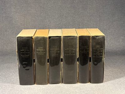 four books are stacked on top of each other on a table