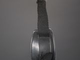 a small metal object hanging from a hook on the wall