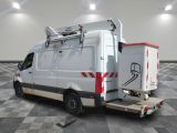 a white van with a ladder on the back of it