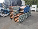 a pile of pipes on a pallet in a parking lot