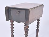 a small wooden table with a drawer on it