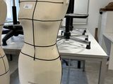 three mannequins on a table in a room