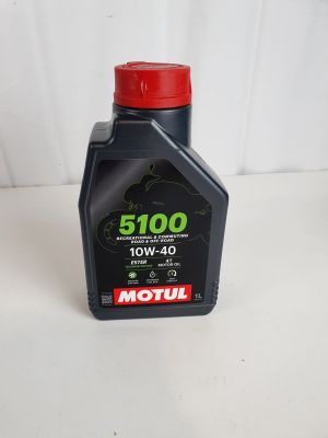 a close up of a bottle of motor oil on a table