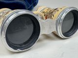 a pair of binoculars sitting on a table next to a blue bag