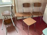 four chairs and a table in a small room