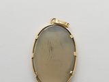 a close up of a gold locke with a picture of a woman ' s face