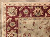 an image of a red and beige area rug on a wooden floor