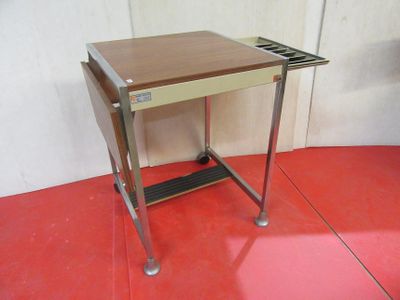 a small table with a tray on it on a red floor