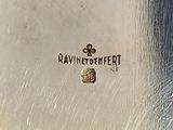 a close up of a silver plate with a logo on it