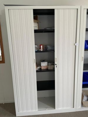 an image of a white closet with shelves and shelves