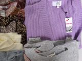 a pile of sweaters sitting on top of a table