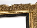 an antique gold frame with a black border and a white background