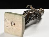 a metal object that is sitting on a white table