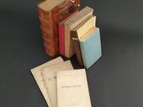 several books are stacked on top of each other on a table