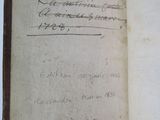 an old book with writing on it sitting on top of a table