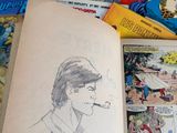 a book with a drawing of a man smoking a cigarette