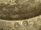 a close up of a metal bowl with a hole in it