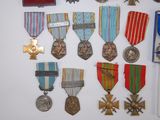many medals and medals displayed on a white surface