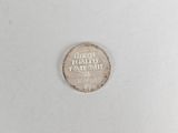 a close up of a coin on a white surface