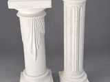 pair of white marble pedestals on a grey background
