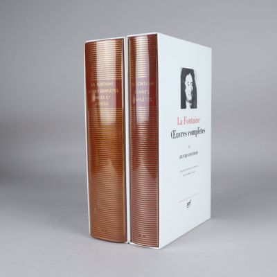 two books are stacked on top of each other on a table