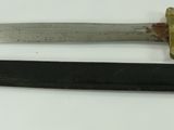 two different types of knives on a white surface