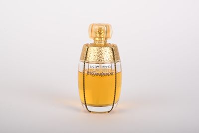 an image of a bottle of perfume on a white surface