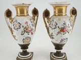 pair of antique vases with floral designs on them on a white background