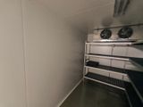 a room with a shelf and a fan in it