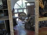a large mirror made out of logs on the floor