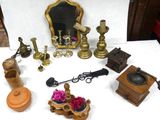 a table with a mirror, a candle holder, a mirror, and other items on it