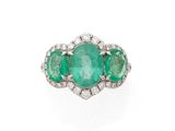 une bague à trois pierres, composée d'une émeraude et de diamants