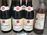 several bottles of wine are lined up on a table