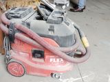 a red vacuum cleaner that is sitting on the floor