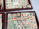 two wooden boxes filled with wooden dominos sitting on top of a table