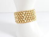 bracelet made of gold metal squares on a mannequin base