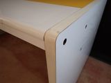 a white desk with a yellow top in a room