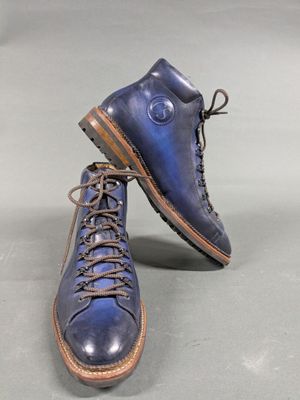 pair of men ' s blue leather boots with laces on them