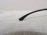 a close up of a pair of glasses on a bed
