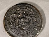a silver plate with a picture of a man riding a horse on it