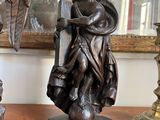 a statue of a man holding a sword on a table