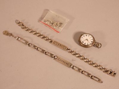 two watches and a bracelet on a table